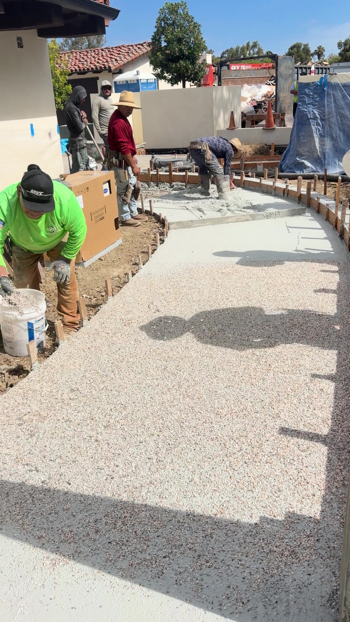 4x8 concrete crew placing and seeding a curved walkway